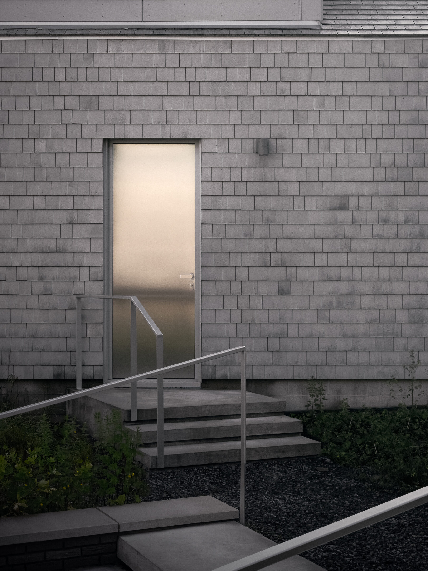 Garage entrance, steel door lit at dusk